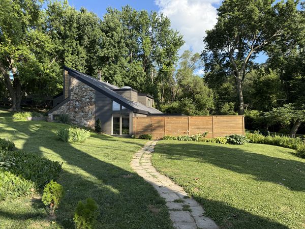 Angular Ponca Hills home with new dark siding, new roof, new windows, and stone accents, wide front view