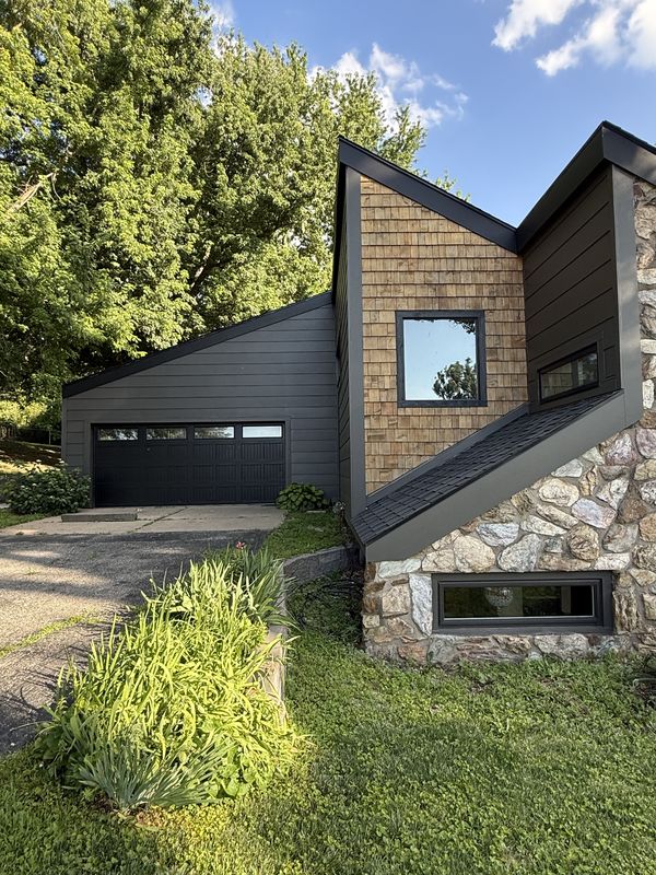 Garage and shake gable with new dark siding and new black-frame windows