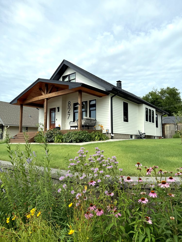 White lap siding home with cedar porch in the Omaha metro